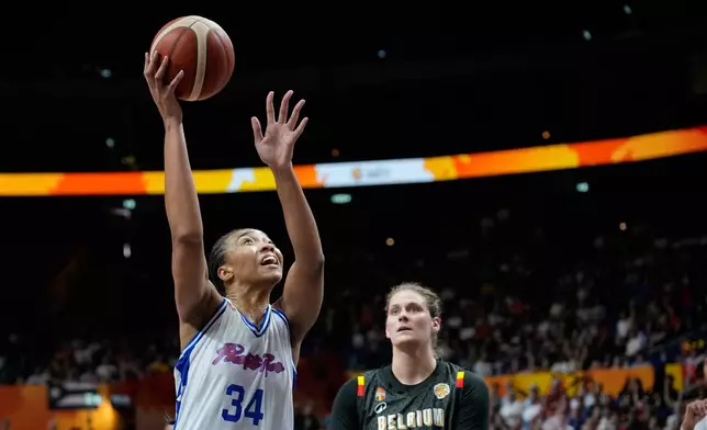 Puerto Rico's Imani McGee-Stafford scores in fornt of pb13[ during the Women's Basketball World Cup match between Puerto Rico and Belgium in Berlin, Sunday, Sept. 6, 2026. (AP Photo/Ebrahim Noroozi)
