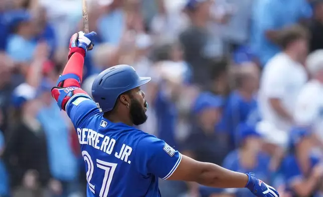 Toronto Blue Jays' Vladimir Guerrero Jr. watches his solo home run while playing against the Baltimore Orioles during the fifth inning of a baseball game in Toronto, Sunday, Sept. 13, 2026. (Nathan Denette/The Canadian Press via AP)