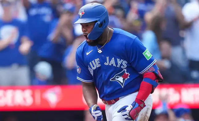 Toronto Blue Jays' Vladimir Guerrero Jr. reacts after hitting a solo home run against the Baltimore Orioles during the fifth inning of a baseball game in Toronto, Sunday, Sept. 13, 2026. (Nathan Denette/The Canadian Press via AP)