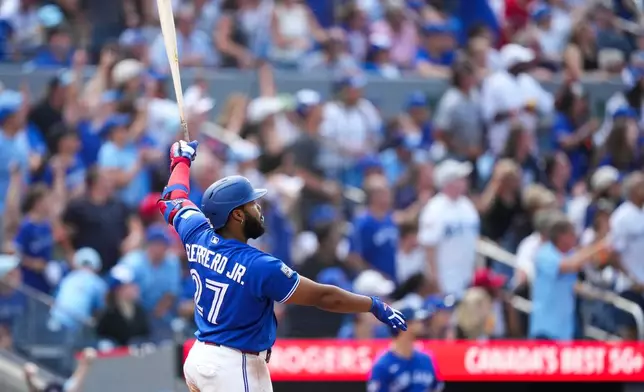 Toronto Blue Jays' Vladimir Guerrero Jr. watches his solo home run while playing against the Baltimore Orioles during the fifth inning of a baseball game in Toronto, Sunday, Sept. 13, 2026. (Nathan Denette/The Canadian Press via AP)