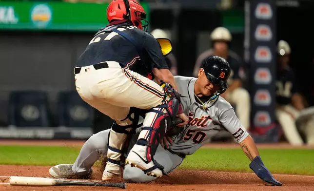 Detroit Tigers' Hao-Yu Lee, right, is tagged out at home plate by Cleveland Guardians catcher Austin Hedges, left, in the third inning of the second baseball game of a split doubleheader in Cleveland, Friday, Sept. 4, 2026. (AP Photo/Sue Ogrocki)