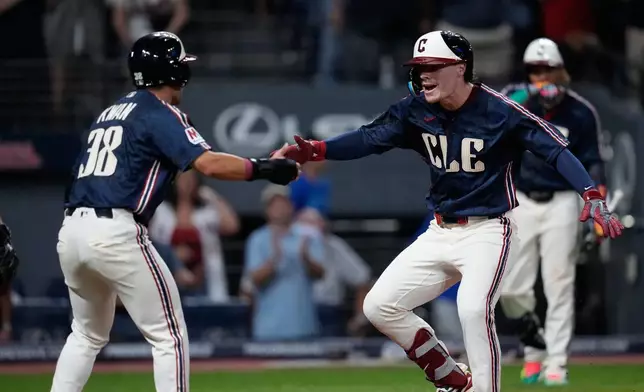 Cleveland Guardians' Travis Bazzana, right, is congratulated by Steven Kwan, left, after hitting a home run in the eighth inning of the second baseball game of a split doubleheader against the Detroit Tigers in Cleveland, Friday, Sept. 4, 2026. (AP Photo/Sue Ogrocki)