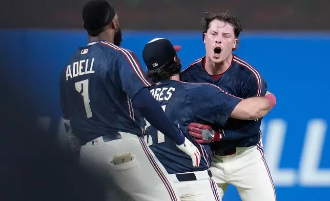 Cleveland Guardians' Travis Bazzana, right, celebrates with teammates after his game winning single in the tenth inning of the second baseball game of a split doubleheader against the Detroit Tigers in Cleveland, Friday, Sept. 4, 2026. (AP Photo/Sue Ogrocki)