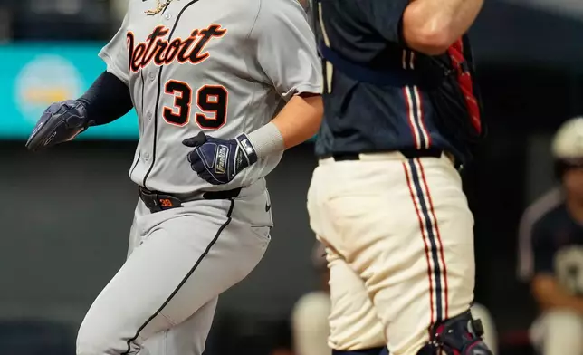 Detroit Tigers' Zach McKinstry (39) scores behind Cleveland Guardians catcher Austin Hedges, right, in the third inning of the second baseball game of a split doubleheader in Cleveland, Friday, Sept. 4, 2026. (AP Photo/Sue Ogrocki)