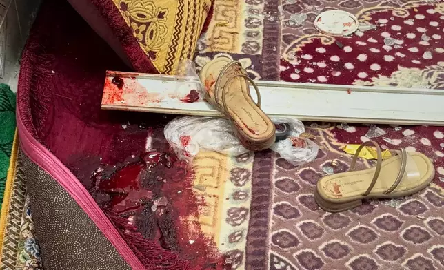 Blood stains are seen next to a pair of sandals on a carpet inside a building that Iranian media said was damaged in a U.S. strike in Kuhestak, southern Iran, early Wednesday, Sept. 2, 2026. (Morteza Akhoondi/Tasnim News Agency via AP)