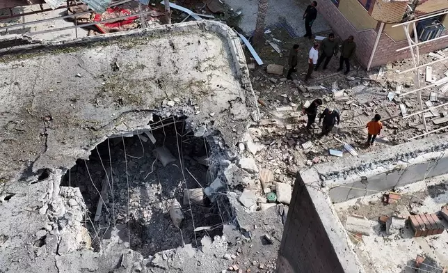 People inspect damage and debris at a building that Iranian media said was hit by a U.S. strike while a wedding celebration was taking place there, in Kuhestak, southern Iran, Wednesday, Sept. 2, 2026. (Morteza Akhoondi/Tasnim News Agency via AP)