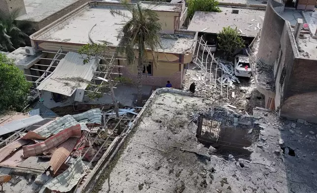An aerial view shows the apparent point of impact on the roof of a building that Iranian media said was hit by a U.S. strike while a wedding celebration was taking place there, in Kuhestak, southern Iran, Wednesday, Sept. 2, 2026. (Morteza Akhoondi/Tasnim News Agency via AP)