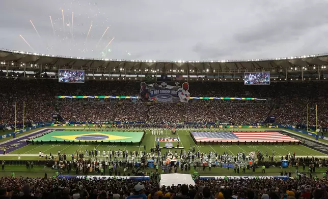 The Brazilian Flag and the United States flag are unfurled during the singing of the Brazilian national anthem before Dallas Cowboys and Baltimore Ravens NFL Game in Rio de Janeiro, Sunday, September 27, 2026. (AP Photo/Gregory Payan)