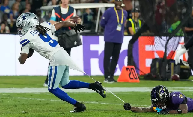 Dallas Cowboys wide receiver Kavontae Turpin (9) is tackled by Baltimore Ravens cornerback Nate Wiggins (2) during the first half of an NFL football game in Rio de Janeiro, Sunday, Sept. 27, 2026. (AP Photo/Fernando Llano)