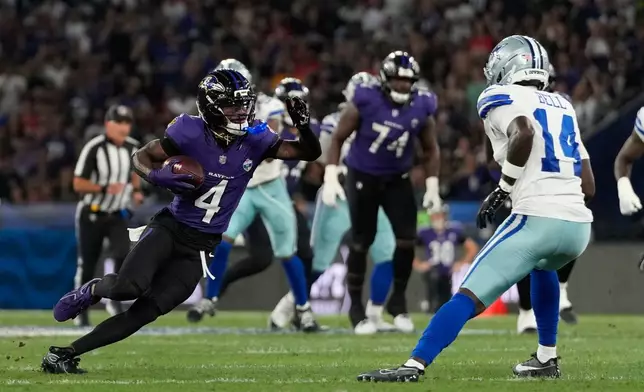 Baltimore Ravens wide receiver Zay Flowers (4) runs the ball against Dallas Cowboys safety Markquese Bell (14) during the first half of an NFL football game in Rio de Janeiro, Sunday, Sept. 27, 2026. (AP Photo/Andre Penner)
