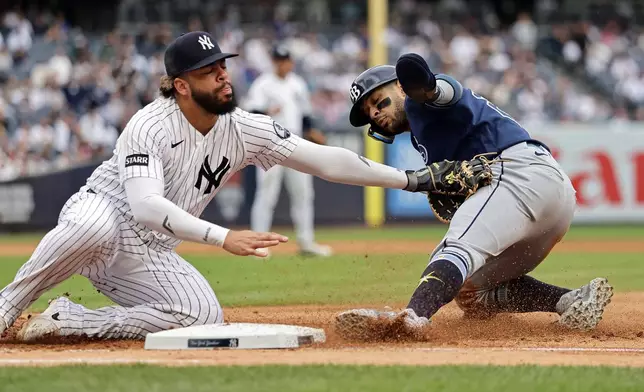 Tampa Bay Rays' Victor Mesa Jr. is tagged out and doubled up by New York Yankees first baseman Luis Garcia Jr. after Tampa Bay Rays' Richie Palacios flied out in the sixth inning during the first baseball game of a doubleheader Tuesday, Sept. 22, 2026, in New York. (AP Photo/Adam Hunger)