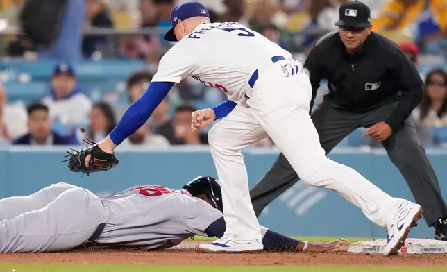 St. Louis Cardinals' Jordan Walker, left, is tagged out at first by Los Angeles Dodgers first baseman Freddie Freeman after being caught off base during the fifth inning of a baseball game Thursday, Sept. 3, 2026, in Los Angeles. (AP Photo/Mark J. Terrill)
