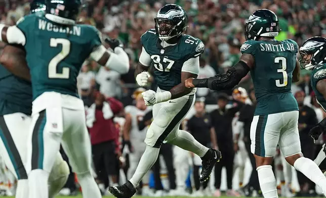 Philadelphia Eagles defensive tackle Moro Ojomo (97) celebrates with teammates after stopping the Washington Commanders on a two-pint conversion attempt during the second half of an NFL football game, Sunday, Sept. 13, 2026, in Philadelphia. (AP Photo/Matt Rourke)