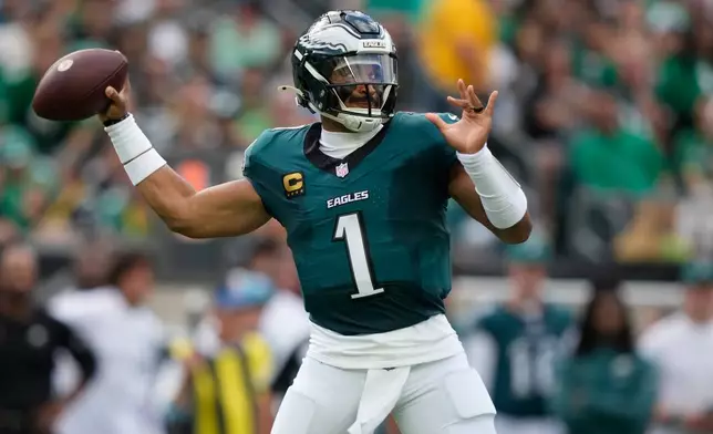 Philadelphia Eagles quarterback Jalen Hurts (1) throws against the Washington Commanders during the first half of an NFL football game, Sunday, Sept. 13, 2026, in Philadelphia. (AP Photo/Matt Slocum)