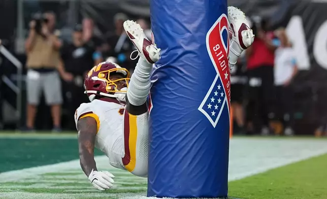 Washington Commanders wide receiver Stefon Diggs (3) celebrates his touchdown against the Philadelphia Eagles during the second half of an NFL football game, Sunday, Sept. 13, 2026, in Philadelphia. (AP Photo/Matt Rourke)
