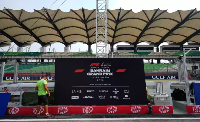 A worker sets up trackside signage during preparations for the Bahrain Grand Prix in Malaysia at the Sepang International Circuit in Sepang, Malaysia, Wednesday, Sept. 30, 2026. (AP Photo/Vincent Thian)