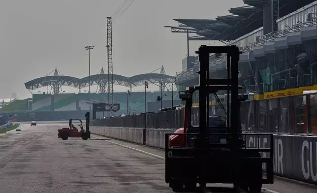 Heavy equipment is driven along the main straight during preparations for the Bahrain Grand Prix in Malaysia at the Sepang International Circuit in Sepang, Malaysia, Wednesday, Sept. 30, 2026. (AP Photo/Vincent Thian)