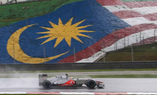 FILE -McLaren Formula One driver Lewis Hamilton of Britain steers his car through the rain during the Malaysian Formula One Grand Prix at Sepang, Malaysia, March 25, 2012. (AP Photo/Mark Baker, File)