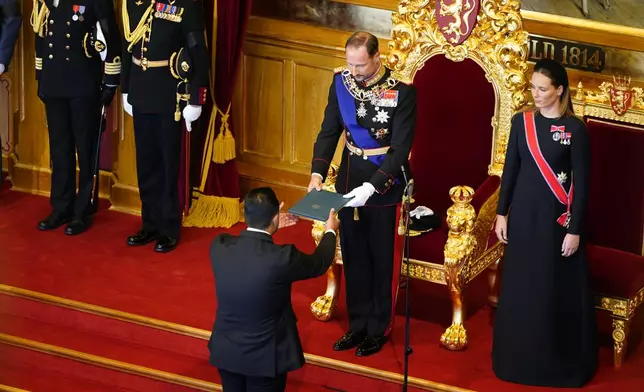 King Haakon VIII. takes the oath according to the Constitution in the Storting, Norway's parliament, accompanied by Crown Princess Ingrid Alexandra, right, in Oslo, Norway, Tuesday, Sept. 1, 2026. (Hakon Mosvold Larsen/Pool Photo via AP)
