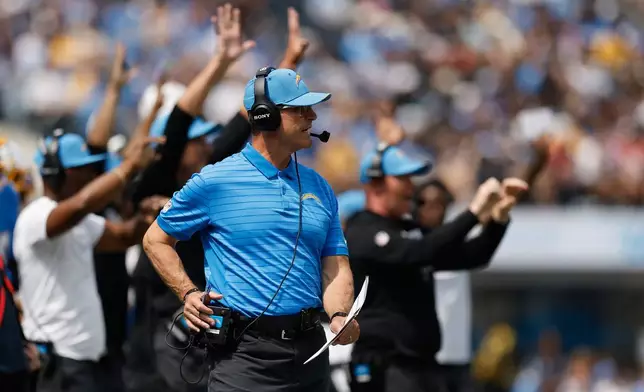 Los Angeles Chargers head coach Jim Harbaugh watches from the sideline during the first half of an NFL football game against the Arizona Cardinals, Sunday, Sept. 13, 2026, in Inglewood, Calif. (AP Photo/Caroline Brehman)