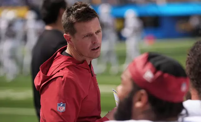 Arizona Cardinals head coach Mike LaFleur talks with players on the sideline during the first half of an NFL football game against the Los Angeles Chargers, Sunday, Sept. 13, 2026, in Inglewood, Calif. (AP Photo/Gregory Bull)