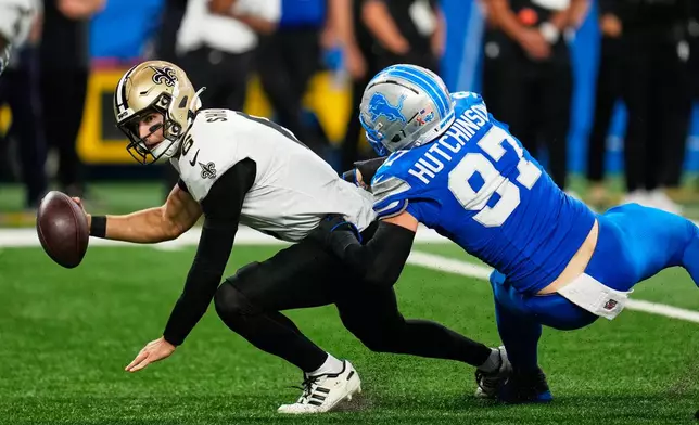New Orleans Saints quarterback Tyler Shough (6) is sacked by Detroit Lions defensive end Aidan Hutchinson (97) in the second half of an NFL football game, Sunday, Sept. 13, 2026, in Detroit.(AP Photo/Paul Sancya)
