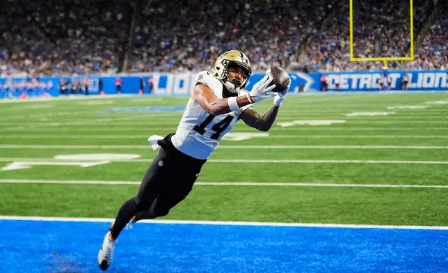 New Orleans Saints wide receiver Devaughn Vele (14) pulls in a touchdown reception against the Detroit Lions in the second half of an NFL football game, Sunday, Sept. 13, 2026, in Detroit. (AP Photo/Paul Sancya)