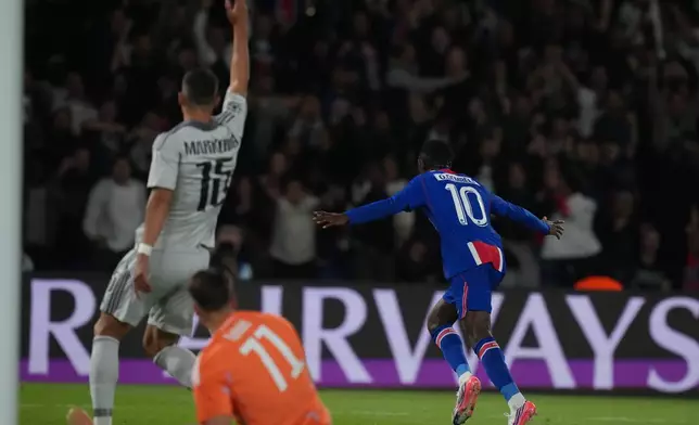 PSG's Ousmane Dembele, right, celebrates after scoring the opening goal during the Champions League opening phase soccer match between PSG and Slovan Bratislava in Paris, Wednesday, Sept. 9, 2026. (AP Photo/Thibault Camus)