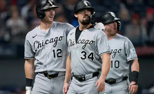 Chicago White Sox's Colson Montgomery (12), Randal Grichuk (34) and Chase Meidroth (10) walk back to the dugout after Montgomery and Meidroth scored and Gricjhuk was tagged out at home on a double hit by Kyle Teel in the sixth inning of a baseball game in Cleveland, Monday, Sept. 14, 2026. (AP Photo/Sue Ogrocki)