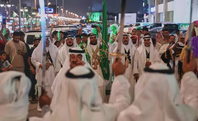 Men perform the traditional Saudi sword dance known as the ardah during celebrations marking Saudi Arabia's 96th National Day in Riyadh, Saudi Arabia, Wednesday, Sept. 23, 2026. (AP Photo/Baraa Anwer)