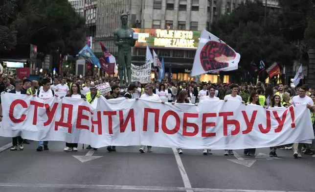 Political candidates, students and citizens carry signatures for the "Student list - Students win" to the Republic Election Commission towards participation in the upcoming parliamentary elections in Belgrade, Serbia, Monday, Sept. 14, 2026. (AP Photo/Darko Vojinovic)