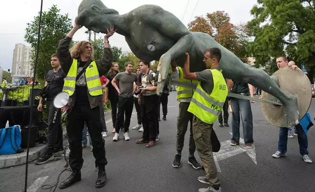 Students prepare a replica of the "Victor" monument, symbol of Belgrade, ahead of the "Student list - Students win" march to the Republic Election Commission towards participation in the upcoming parliamentary elections in Belgrade, Serbia, Monday, Sept. 14, 2026. (AP Photo/Darko Vojinovic)