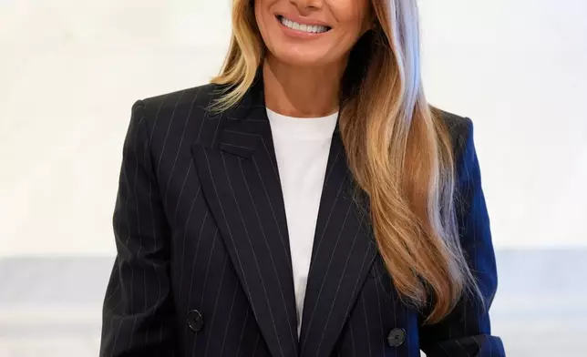 First lady Melania Trump signs the guest book as she prepares to ring the opening bell at the New York Stock Exchange Wednesday, Sept. 23, 2026, in New York. (AP Photo/Seth Wenig)