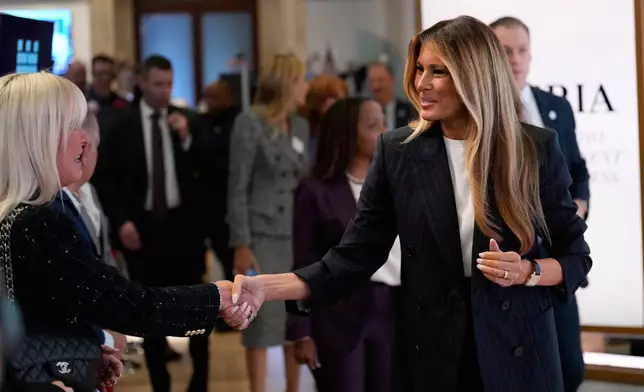 First lady Melania Trump, right, shakes hands as she prepares to ring the opening bell at the New York Stock Exchange Wednesday, Sept. 23, 2026, in New York. (AP Photo/Seth Wenig)