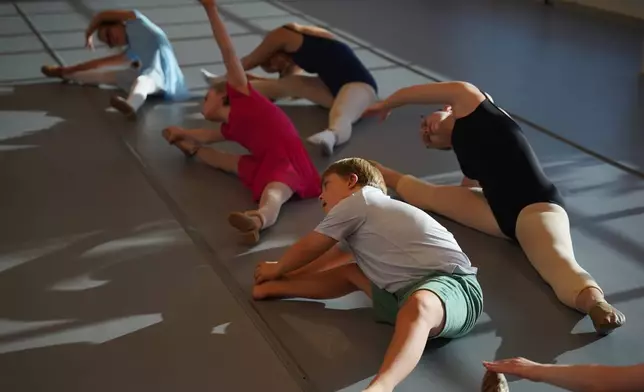 Students perform dance moves on the floor during a Dance Abilities class at the Academy of Dance Arts in the Indianapolis suburb of Fishers, Ind., Thursday, Sept. 17, 2026. (AP Photo/Obed Lamy)