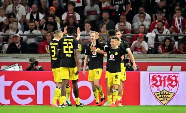 Borussia Dortmund's Maximilian Beier, center, celebrates scoring with teammates during the Bundesliga soccer match between VfB Stuttgart and Borussia Dortmund in Stuttgart, Germany, Saturday Sept. 19, 2026. (Jan-Philipp Strobel/dpa via AP)