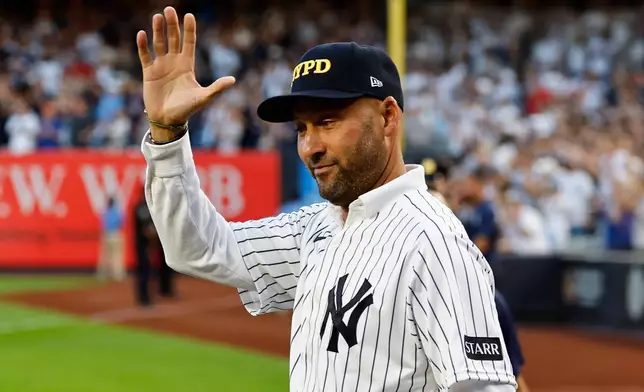 Former New York Yankee Derek Jeter acknowledges fans during a 9/11 ceremony before a baseball game against the New York Mets, Friday, Sept. 11, 2026, in New York. (AP Photo/Noah K. Murray)