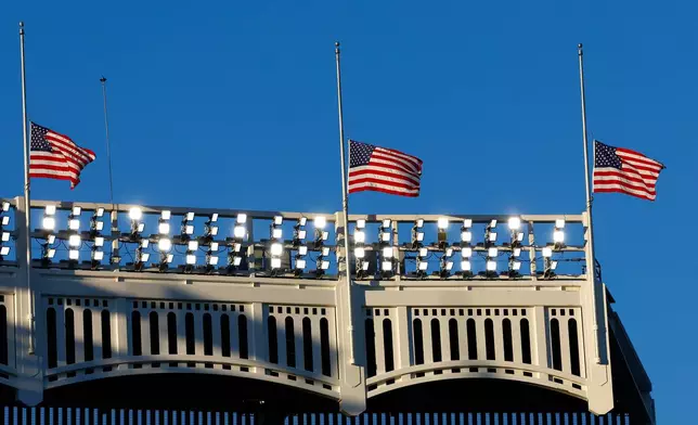 American flags stand at half staff during a 9/11 ceremony before baseball game between the New York Yankees and the New York Mets, Friday, Sept. 11, 2026, in New York. (AP Photo/Noah K. Murray)