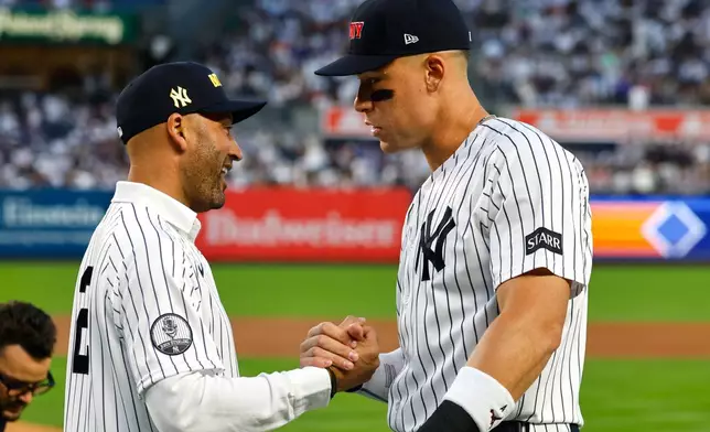 Former New York Yankee Derek Jeter shakes hands with Aaron Judge before baseball game against the New York Mets, Friday, Sept. 11, 2026, in New York. (AP Photo/Noah K. Murray)