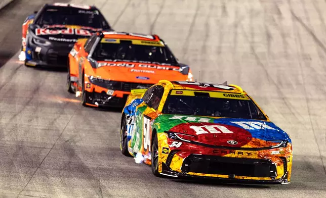 Ty Gibbs (54), in the throwback M&M's car honoring the late Kyle Busch, leads Ryan Preece and Connor Zilisch during a NASCAR Cup Series auto race Saturday, Sept. 19, 2026, in Bristol, Tenn. (AP Photo/Wade Payne)