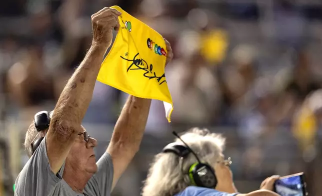 A fan holds up a yellow towel on the 18th lap to honor the late Kyle Busch during a NASCAR Cup Series auto race Saturday, Sept. 19, 2026, in Bristol, Tenn. (AP Photo/Wade Payne)