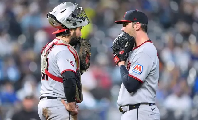 Cleveland Guardians catcher Austin Hedges, left, and starting pitcher Gavin Williams meet on the mound during the fourth inning of a baseball game against the Kansas City Royals, Friday, Sept. 25, 2026, in Kansas City, Mo. (AP Photo/Charlie Riedel)