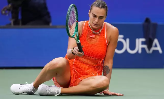 Aryna Sabalenka, of Belarus, reacts after she falls over while competing against Elena Rybakina, of Kazakhstan, during the women's singles final of the U.S. Open tennis championships Saturday, Sept. 12, 2026, in New York. (AP Photo/Kirsty Wigglesworth)