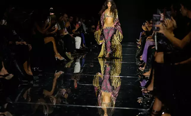 A model wears a creation part of the Roberto Cavalli women's Spring-Summer 2027 collection, presented in Milan, Italy, Thursday, Sept. 24, 2026. (AP Photo/Luca Bruno).