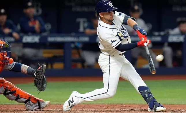 Tampa Bay Rays' Nick Madrigal connects for a run scoring sacrifice fly off Houston Astros pitcher Bennett Sousa during the seventh inning of a baseball game Saturday, Sept. 12, 2026, in St. Petersburg, Fla. (AP Photo/Chris O'Meara)