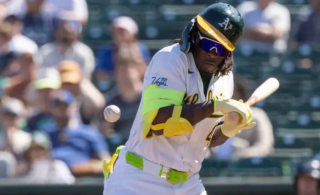 Athletics' Lawrence Butler reacts after being hit by a pitch while at-bat during the third inning of a baseball game against the Seattle Mariners, Sunday, Sept. 13, 2026, in West Sacramento, Calif. (AP Photo/Sara Nevis)