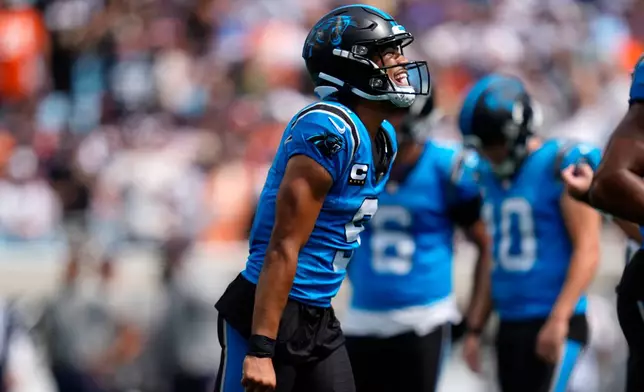 Carolina Panthers quarterback Bryce Young (9) celebrates after scoring a touchdown during the first half of an NFL football game, Sunday, Sept. 13, 2026, in Charlotte, N.C. (AP Photo/Erik Verduzco)