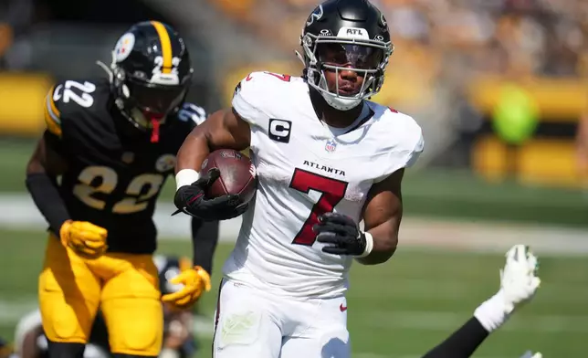 Atlanta Falcons running back Bijan Robinson (7) runs in for a touchdown during an NFL football game against the Pittsburgh Steelers, Sunday, Sept. 13, 2026, in Pittsburgh. (AP Photo/Gene J. Puskar)