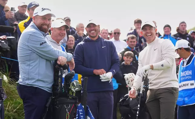 Golfers, from left, Shane Lowry, of Ireland, Brooks Koepka, of the United States, and Rory McIlroy of Northern Ireland, laugh during the first round of the Irish Open golf tournament, Thursday, Sept. 10, 2026, in Doonbeg, Ireland. (Brian Lawless/PA via AP)