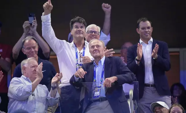 Dick Gould, center, a 17-time champion coach at Stanford, looks on as he is honored at the U.S. Open tennis championships, Saturday, Sept. 5, 2026, in New York. (AP Photo/Frank Franklin II)